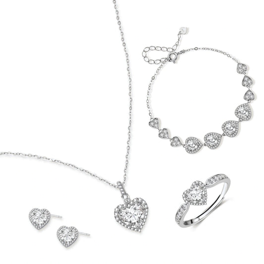Complete jewelry set with heart-shaped sterling silver pieces featuring brilliant moissanite stones on white background.