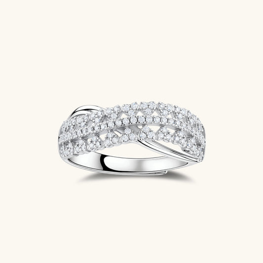 Sterling silver over ring with pavé-set moissanite stones creating an elegant infinity design on neutral background