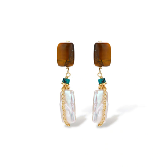 Gold-plated drop earrings with amber stones, teal beads, and wire-wrapped baroque pearls on cream background.