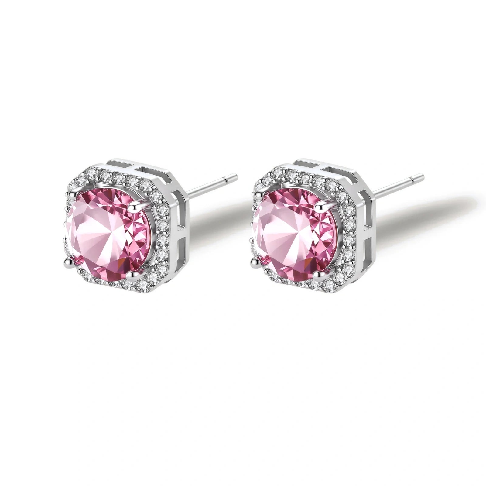 Pink moissanite studs in octagonal sterling silver halo settings with sparkling accent stones on cream background.