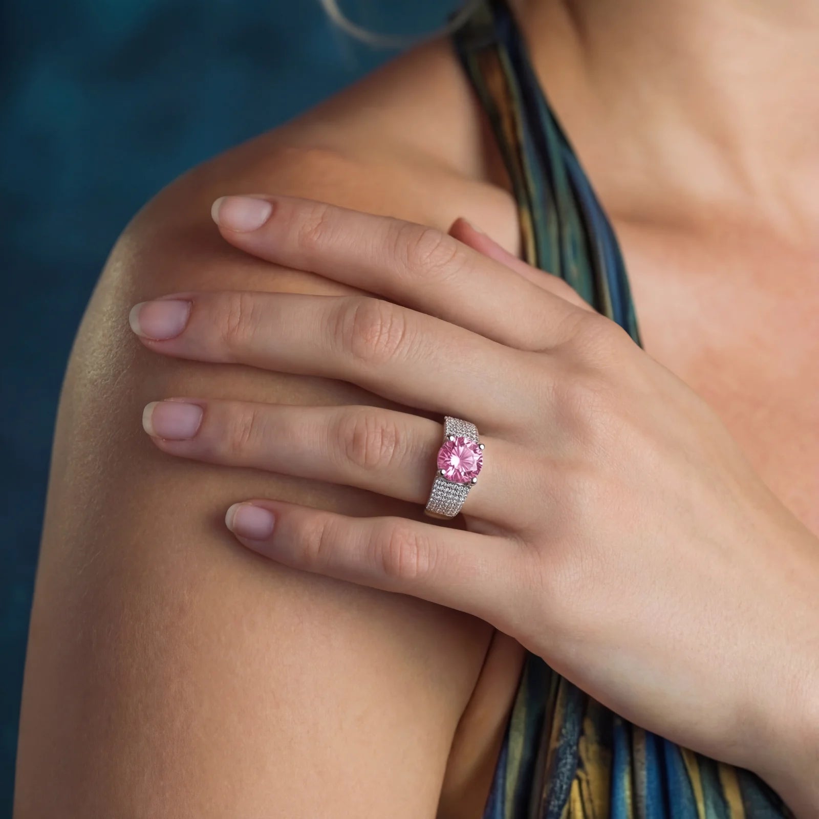 Sterling silver jewelry set featuring pink moissanite stones in halo settings on white background.