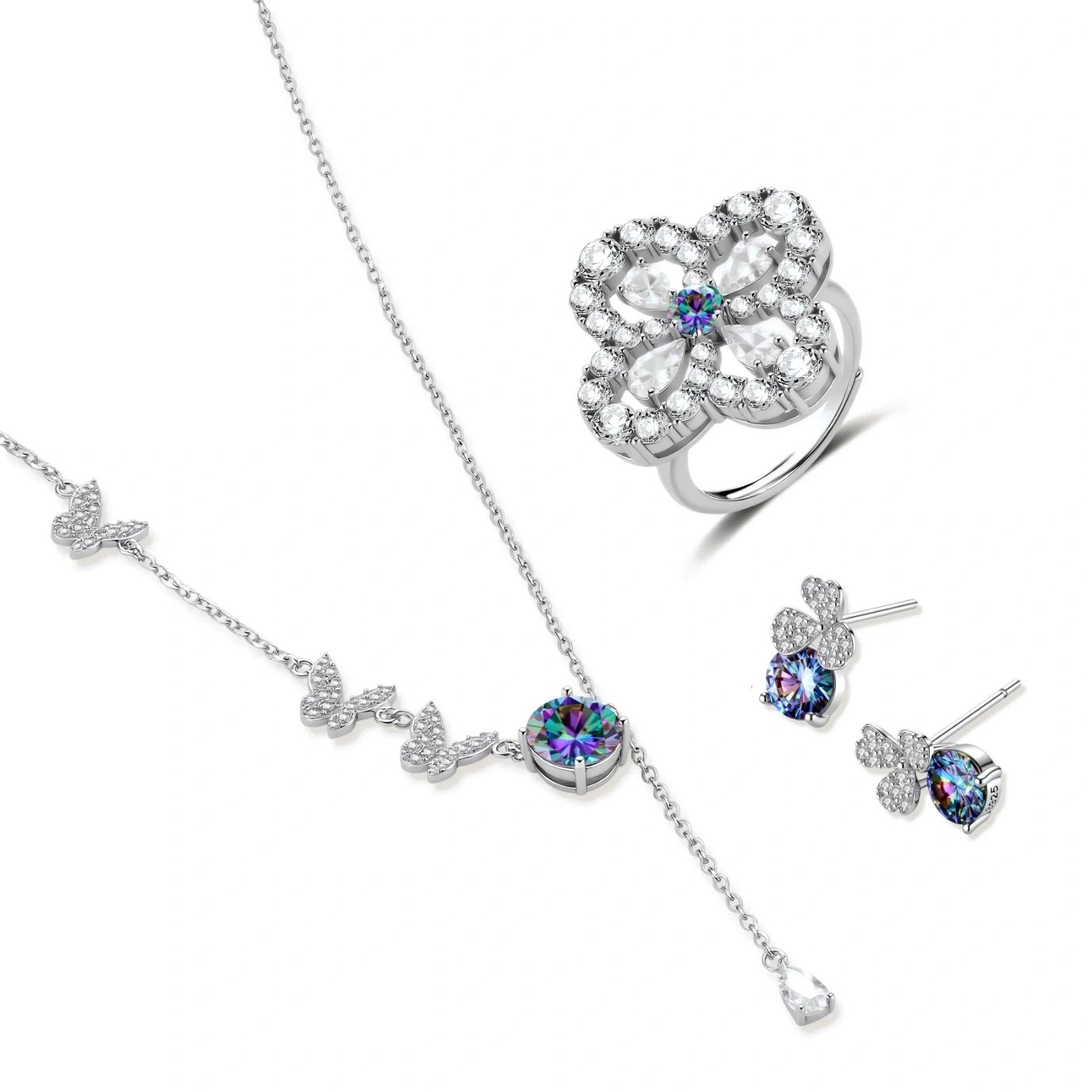 Sterling silver jewelry set with rainbow moissanite stones in clover and butterfly designs on cream background