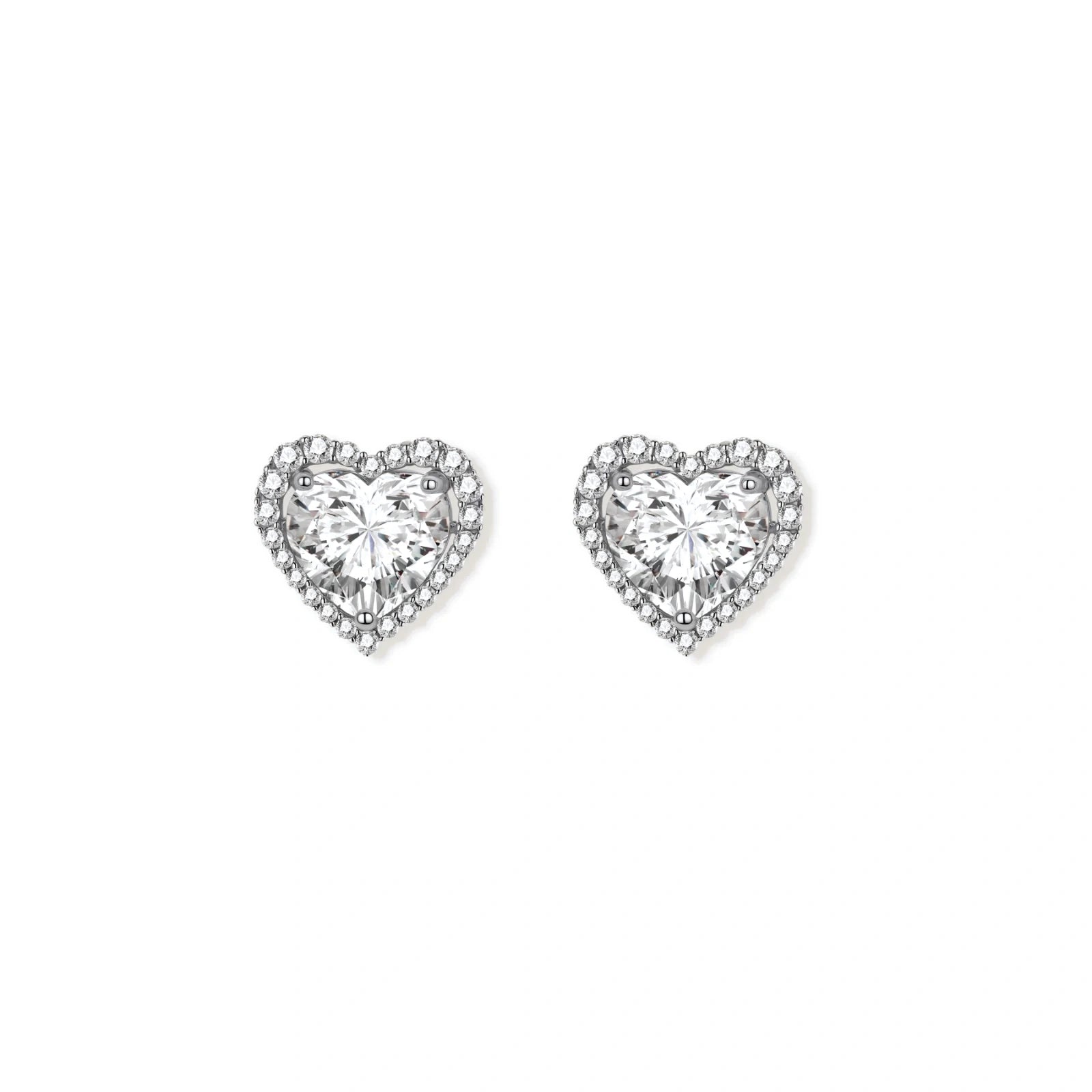 Close-up of heart-shaped moissanite stud earrings in sterling silver halo setting on cream background.