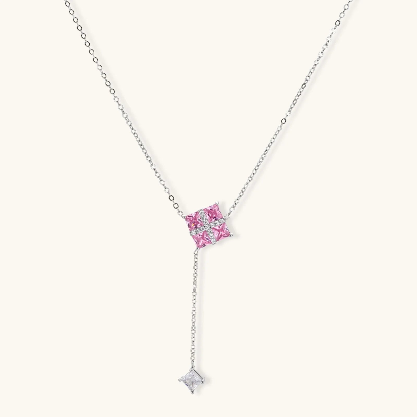 White gold plated jewelry set with pink cubic zirconia stones in geometric  design, featuring Y-necklace and square stud earrings
