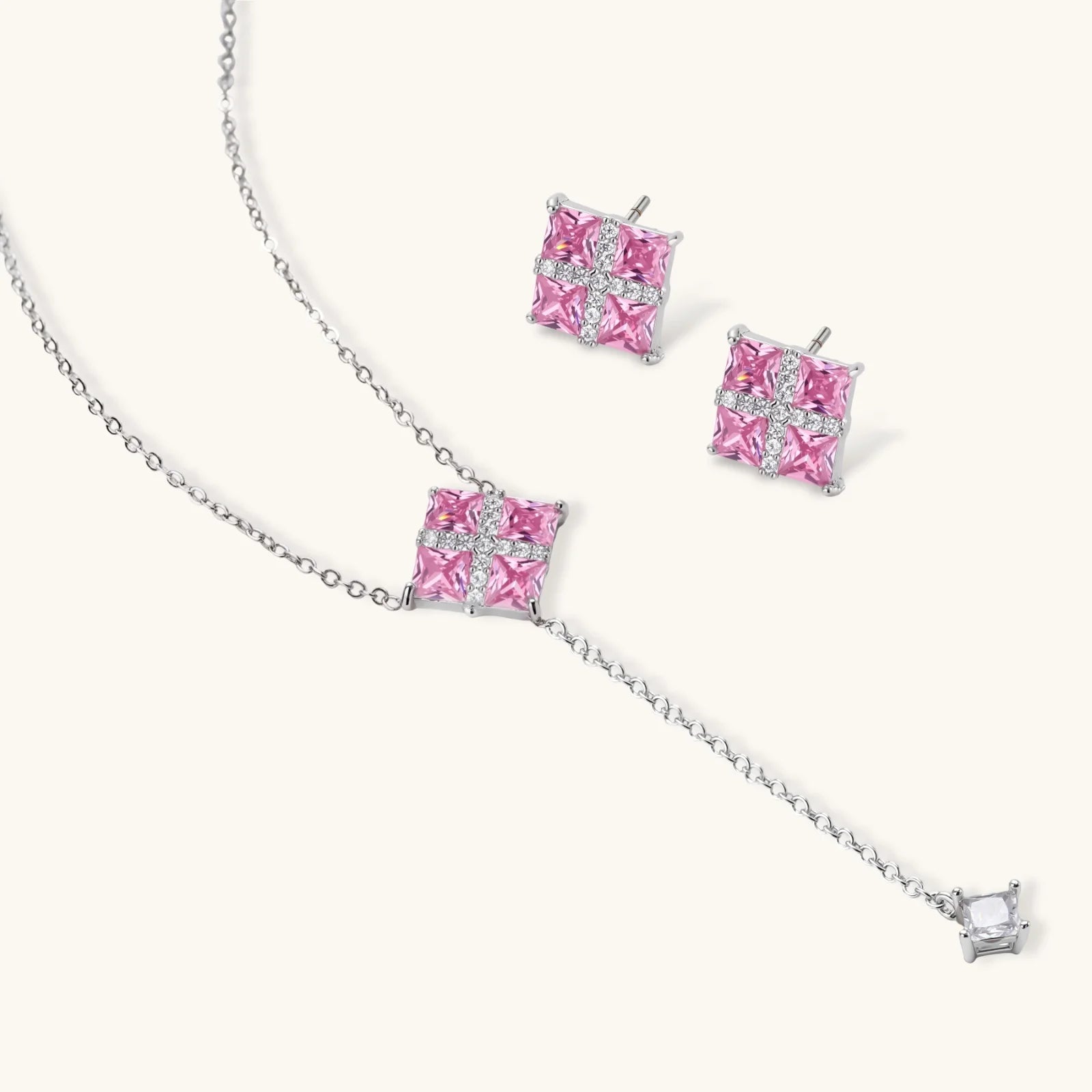 White gold plated jewelry set with pink cubic zirconia stones in geometric  design, featuring Y-necklace and square stud earrings