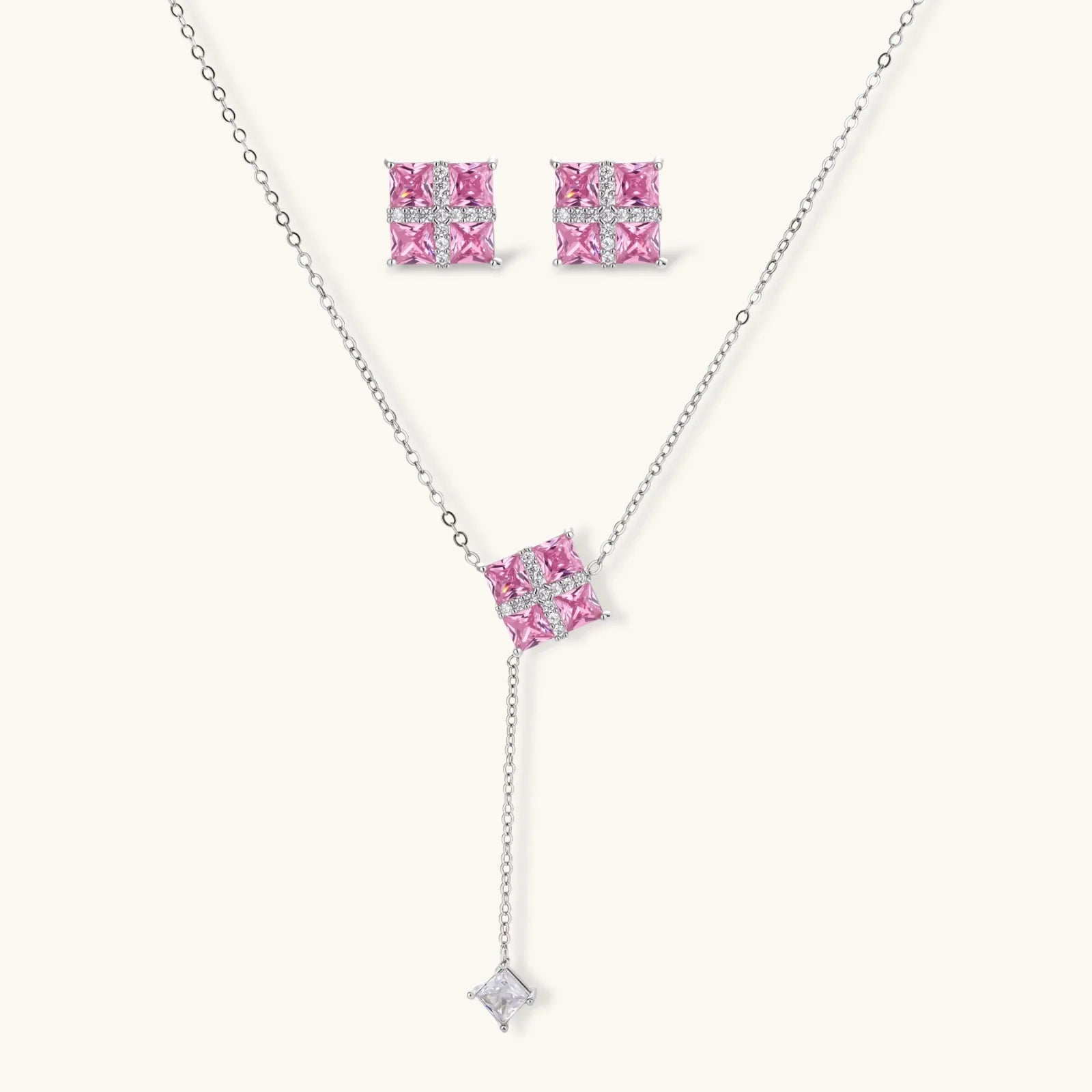 White gold plated jewelry set with pink cubic zirconia stones in geometric  design, featuring Y-necklace and square stud earrings