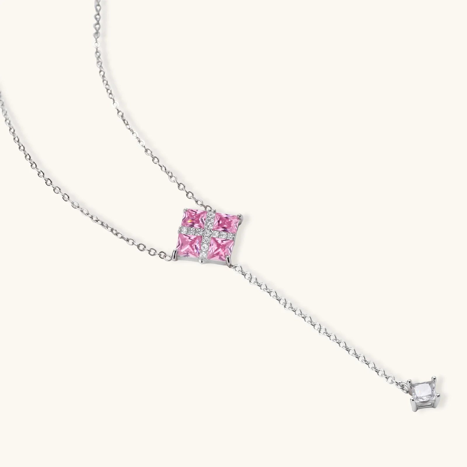 White gold plated jewelry set with pink cubic zirconia stones in geometric  design, featuring Y-necklace and square stud earrings