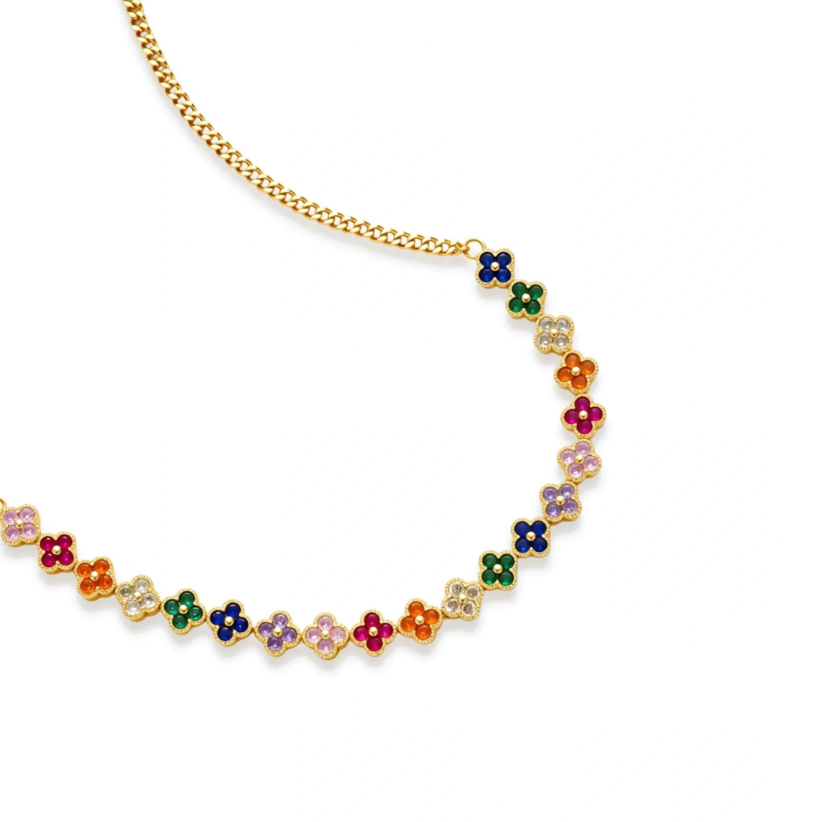 Colorful four-leaf clover jewelry set with rainbow cubic zirconia stones in gold-plated setting on white background