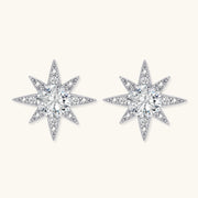 Sterling silver star-shaped stud earrings with brilliant moissanite center stones and pavé details on neutral background.