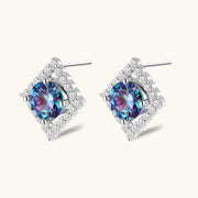 Diamond-shaped sterling silver stud earrings with rainbow moissanite centers surrounded by crystal halos