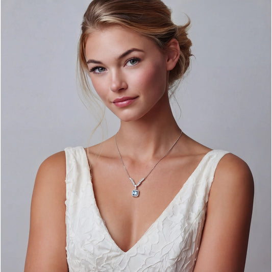 Woman wearing an Arc Moissanite Necklace featuring a 14K gold plated and sterling silver pendant with ethically sourced materials, styled with a white textured dress.