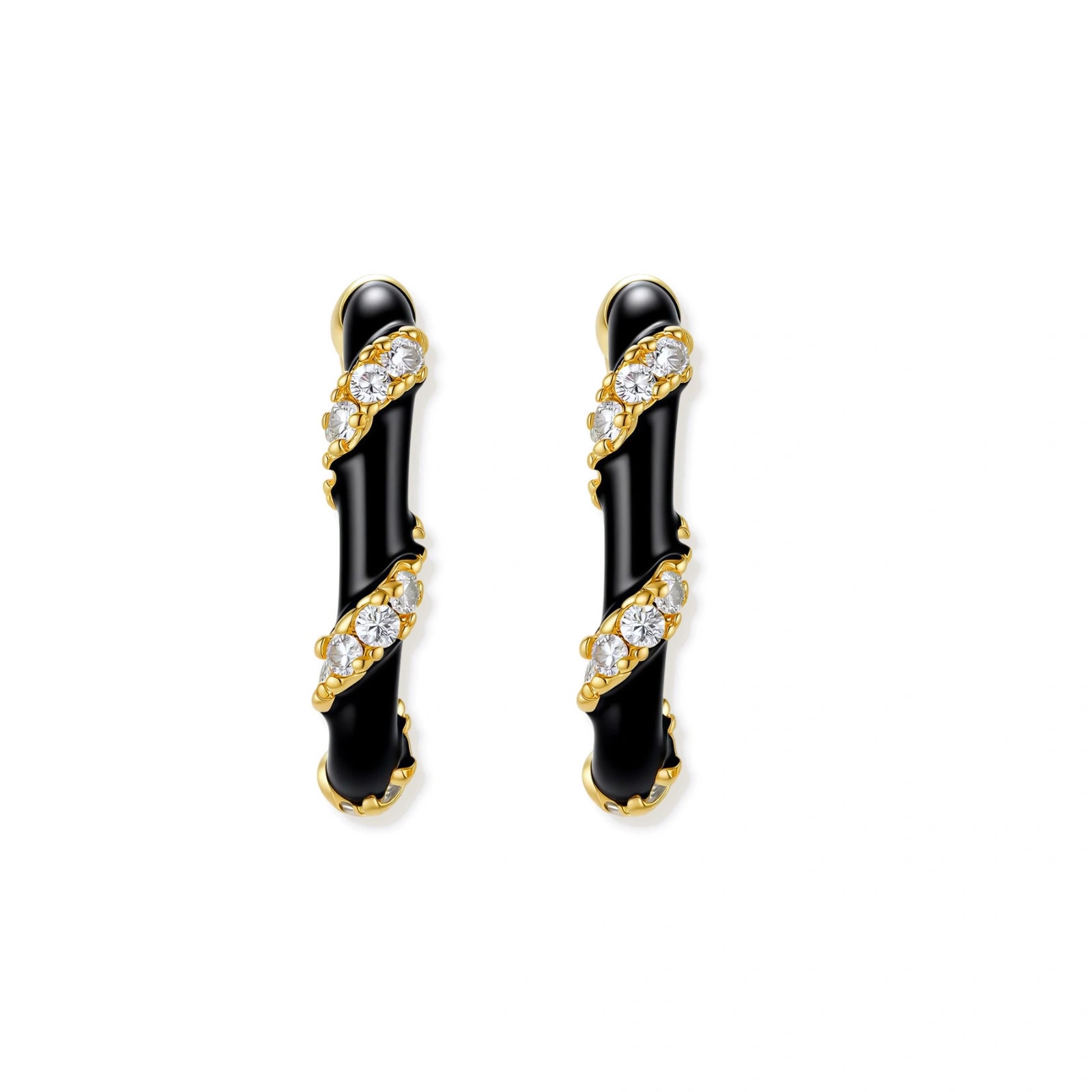 Small gold-plated hoop earrings with black enamel stripes and cubic zirconia crystals on white background.