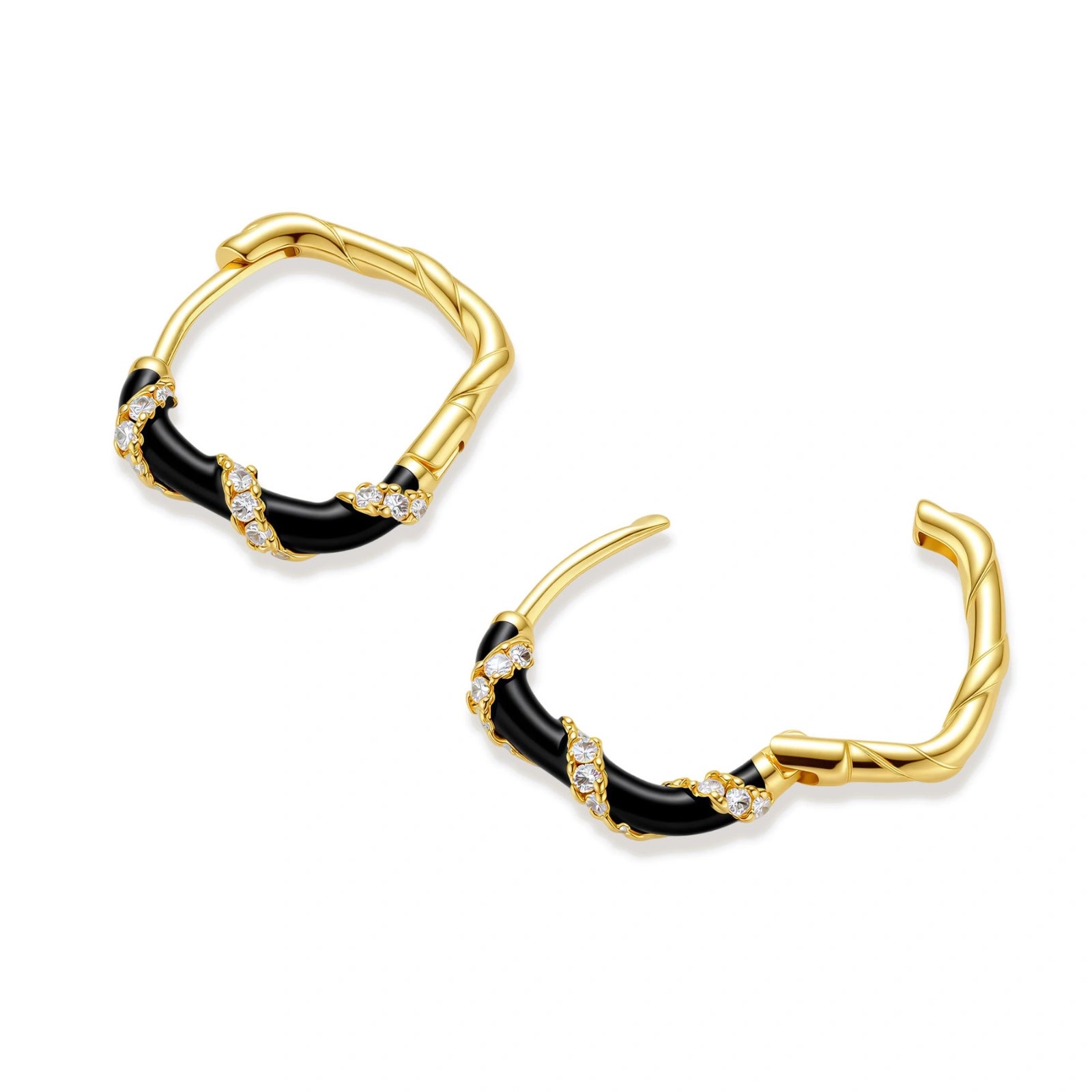 Small gold-plated hoop earrings with black enamel stripes and cubic zirconia crystals on white background.