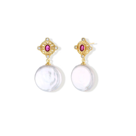 Gold baroque pearl earrings with pink gemstone studs and ornate detailing on cream background.