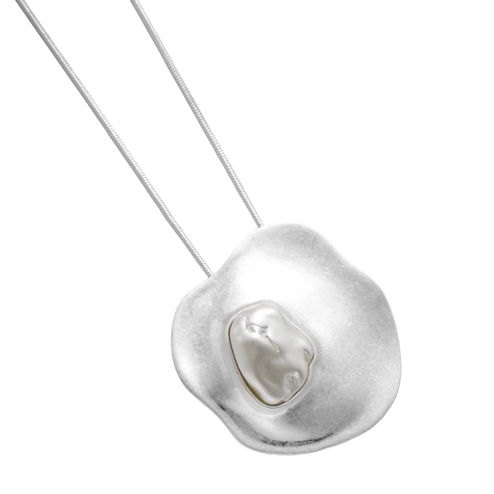 Organic curved earrings and necklace featuring baroque pearls in eco-zinc alloy settings on neutral background