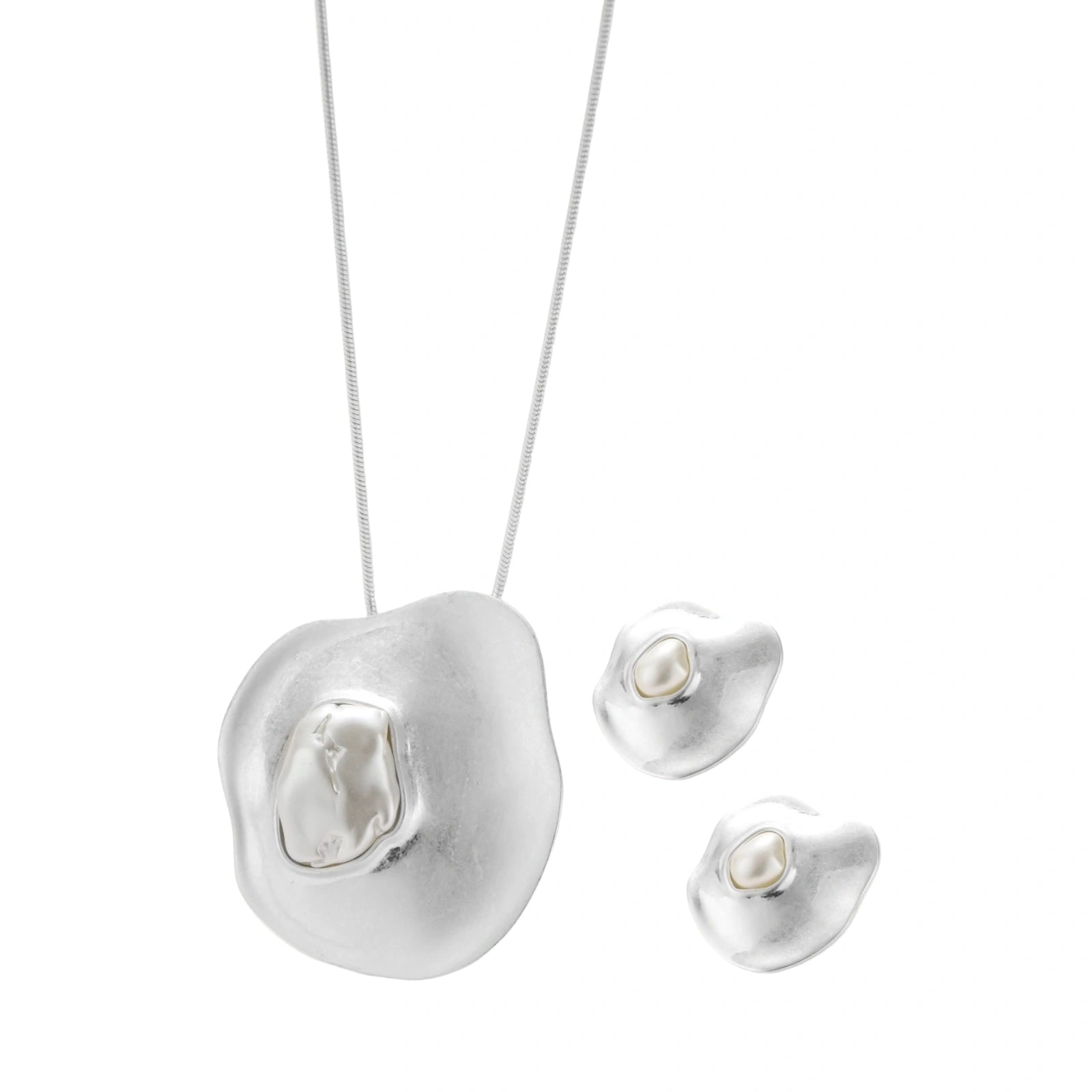 Organic curved earrings and necklace featuring baroque pearls in eco-zinc alloy settings on neutral background