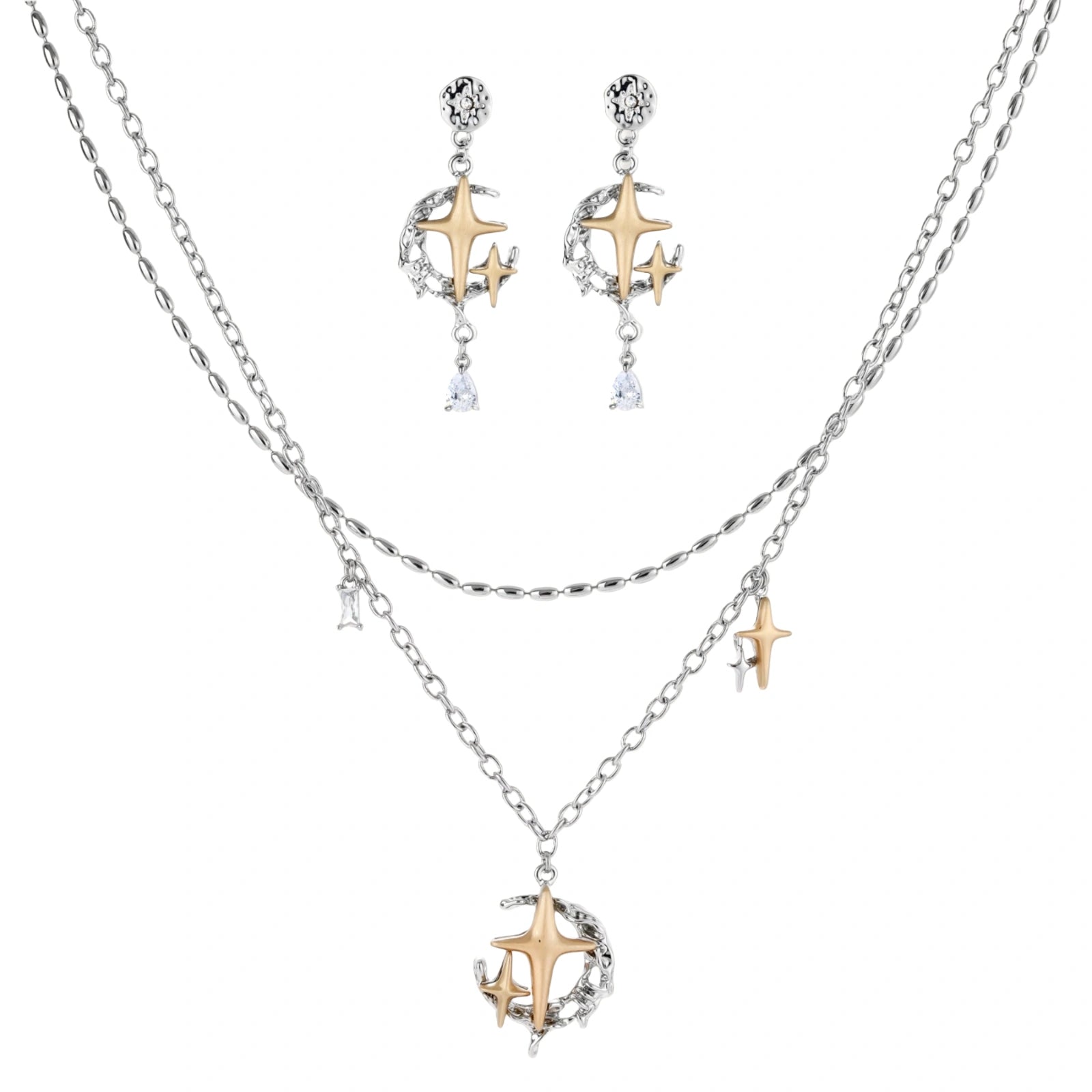 Delicate eco-brass jewelry set featuring gold star and silver moon crescents with clear zirconia crystal drops on cream background