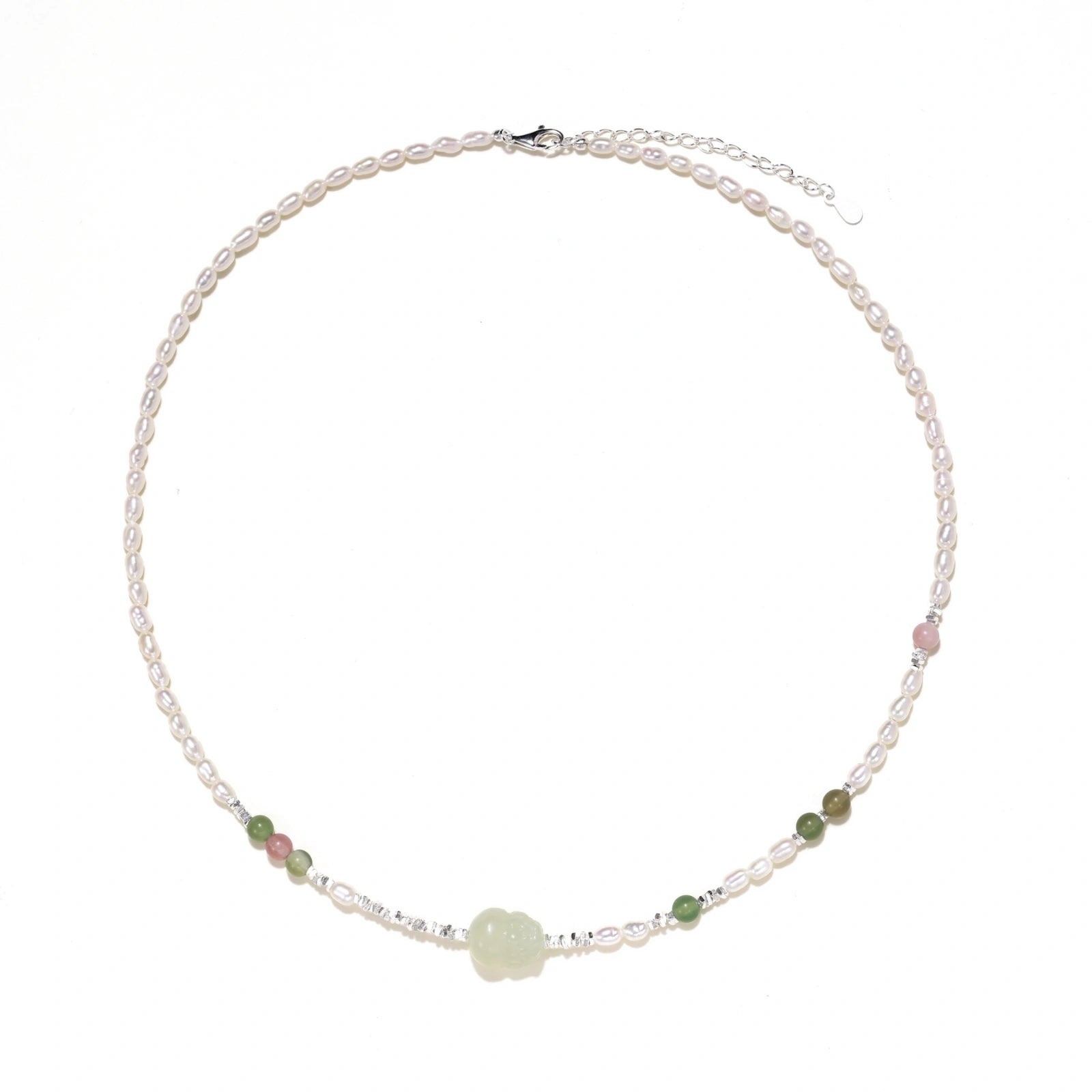 Delicate pearl necklace with pale green serpentine jade centerpiece and colorful agate beads on cream background