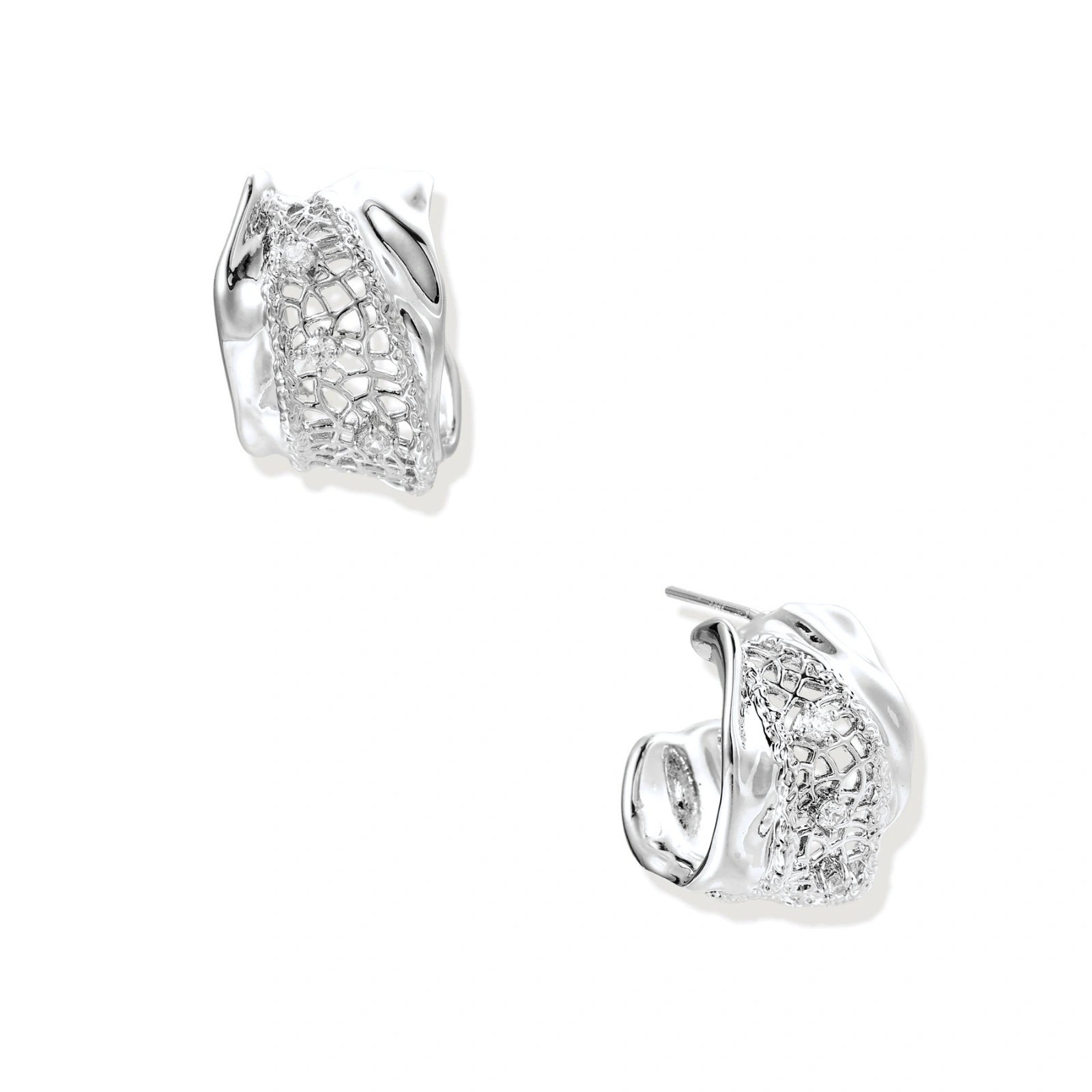 Close-up of sculptural hoop earrings with lattice center band and smooth twisted edges in white gold-plated brass with zirconia
