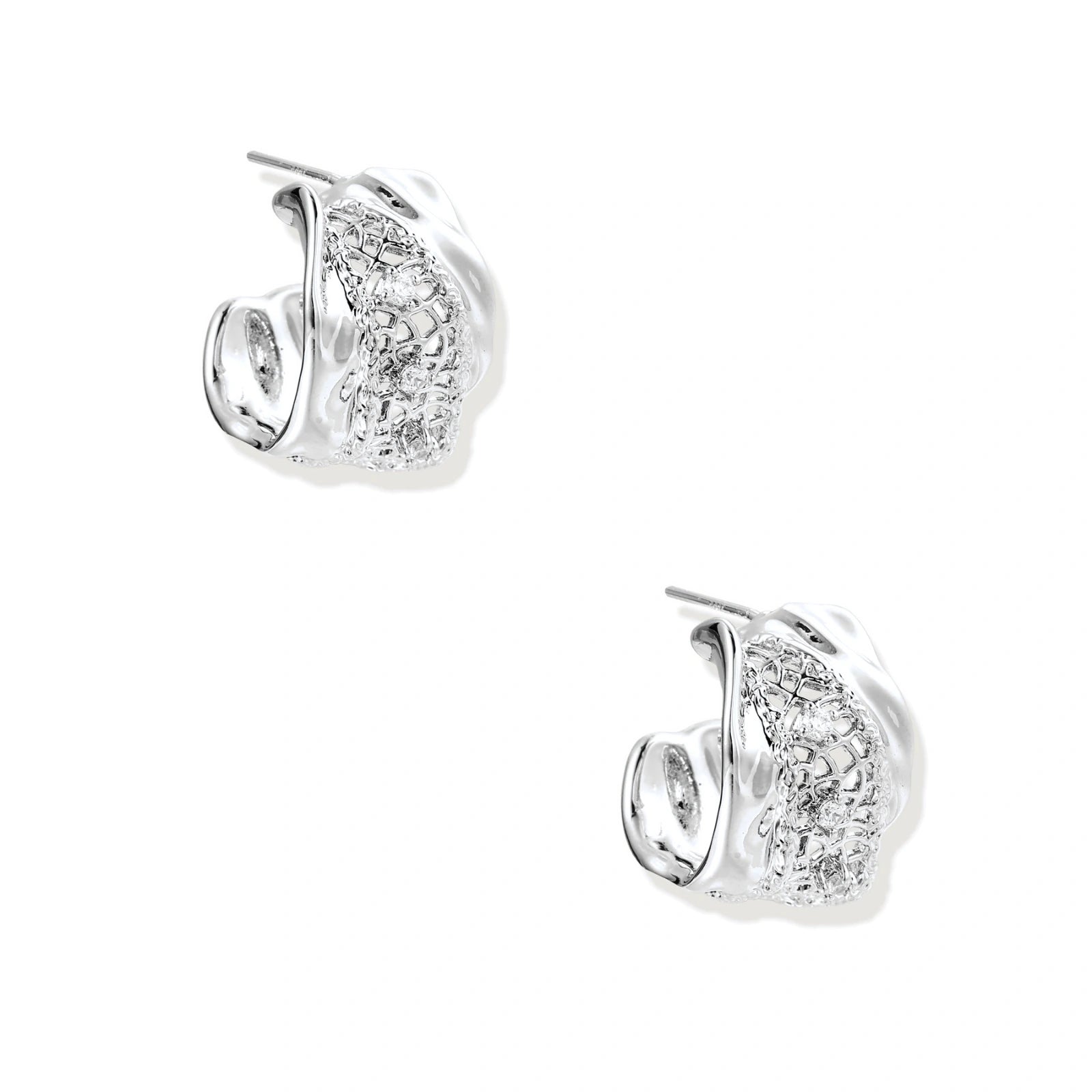 Close-up of sculptural hoop earrings with lattice center band and smooth twisted edges in white gold-plated brass with zirconia