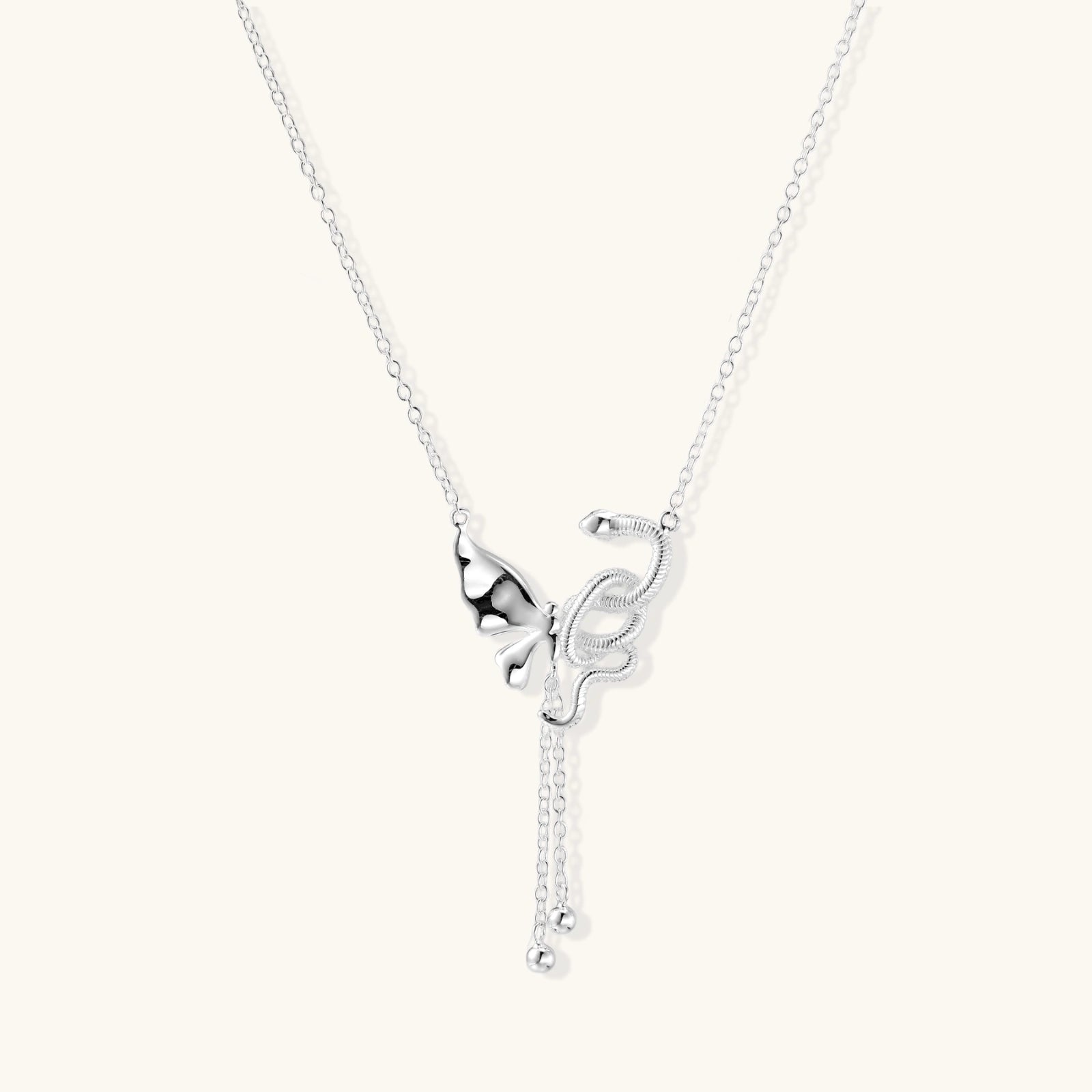 Sterling silver butterfly pendant with textured wing detail on adjustable Y-chain with ball drop ends