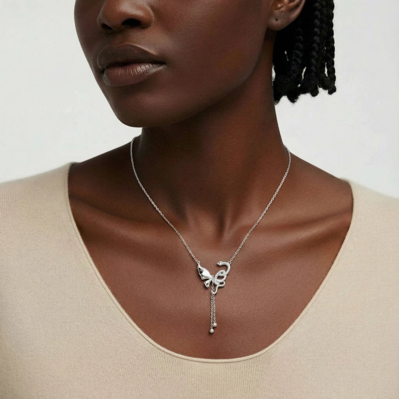 Close-up of a woman wearing the Flutter Dreams Necklace, a sterling silver pendant necklace featuring an elegant, artistic design with a delicate chain from AlbaLuxe luxury jewellery.