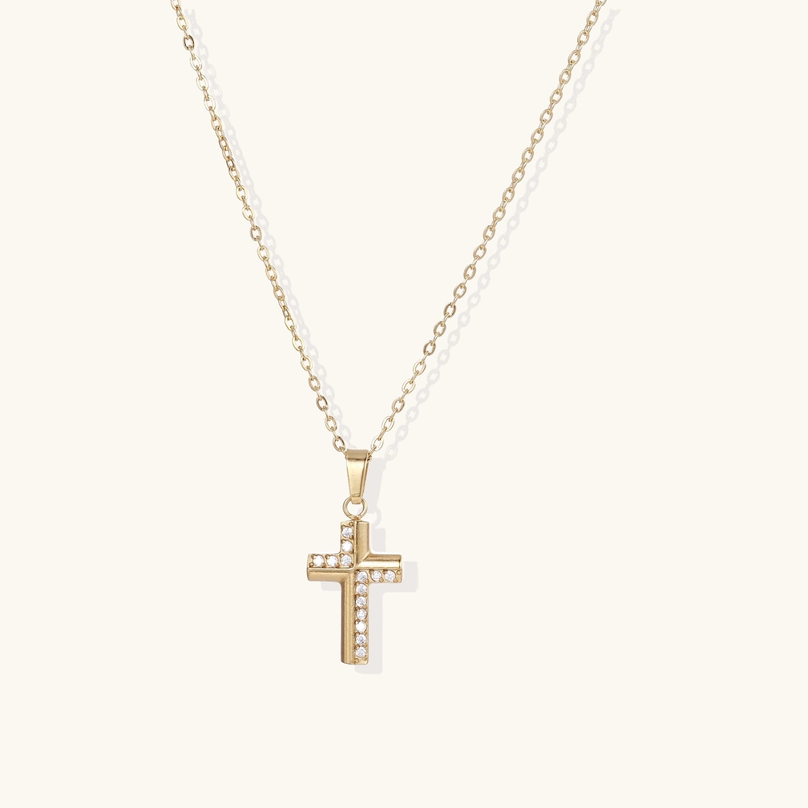 Gold-plated stainless steel  necklace with crystal embellishments on adjustable chain against light background.
