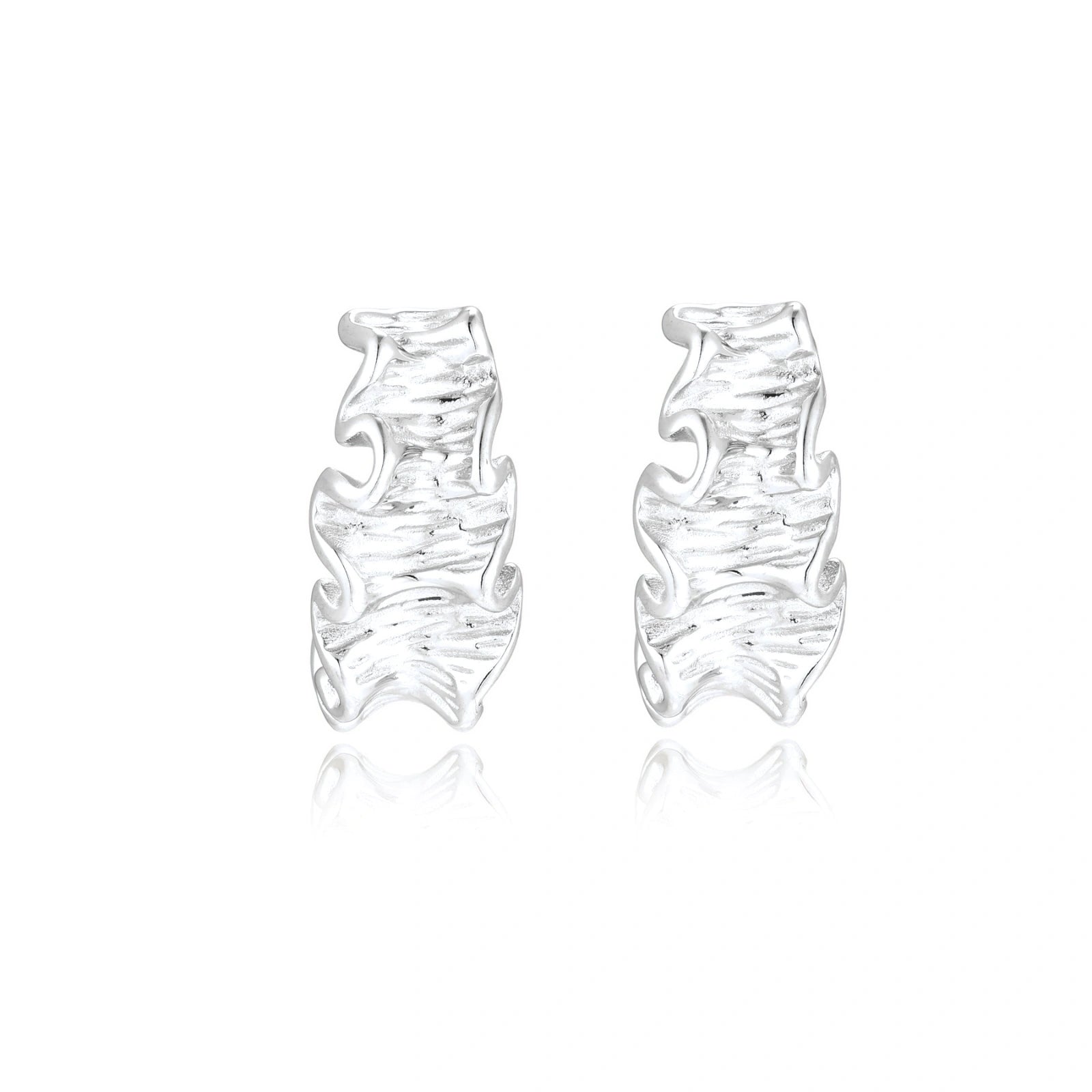 White gold plated sculptural hoop earrings with organic wavy edges and reflective metallic finish on cream background
