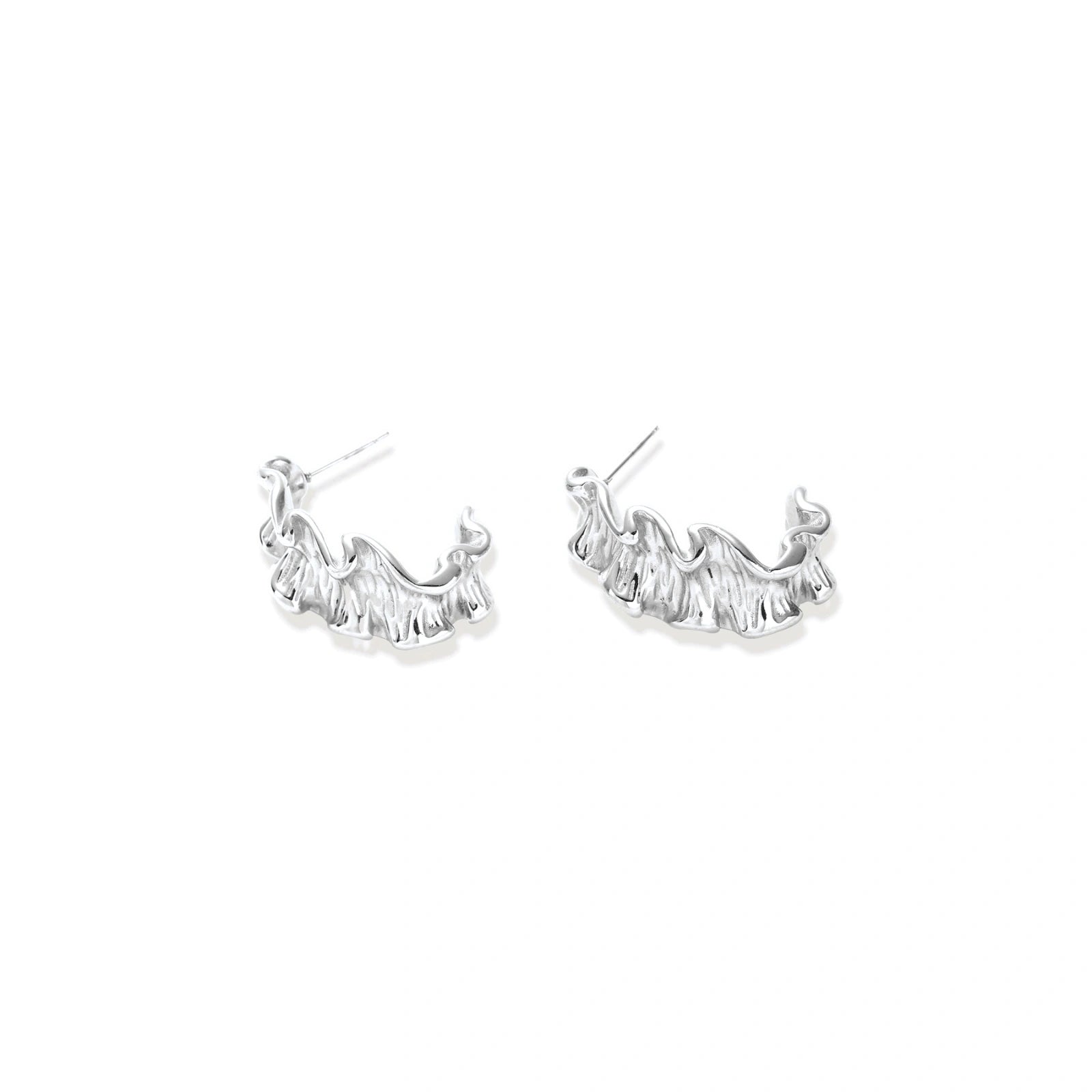 White gold plated sculptural hoop earrings with organic wavy edges and reflective metallic finish on cream background