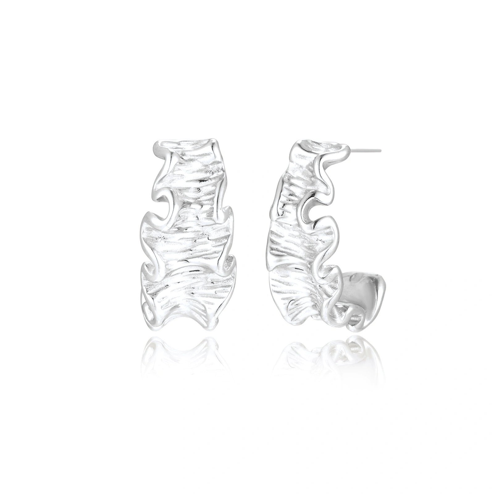 White gold plated sculptural hoop earrings with organic wavy edges and reflective metallic finish on cream background
