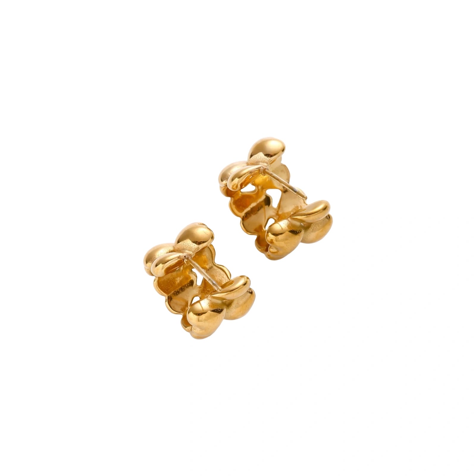 Close-up of gold-plated twisted rope huggie hoop earrings with brushed finish on white background.