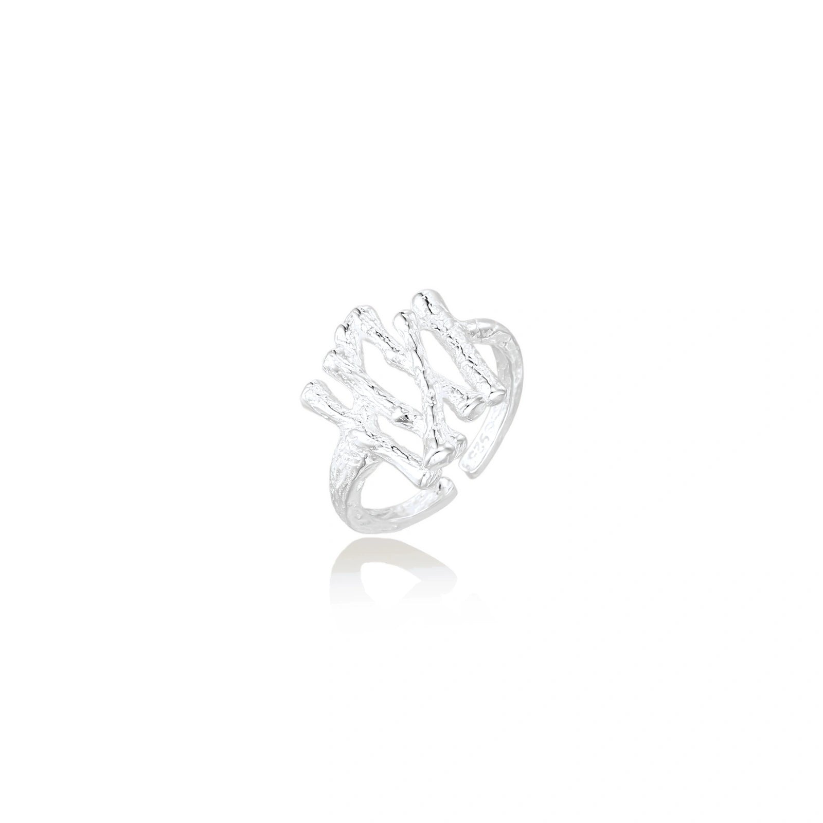 Sculptural sterling silver ring with organic branch design and textured surfaces on cream background