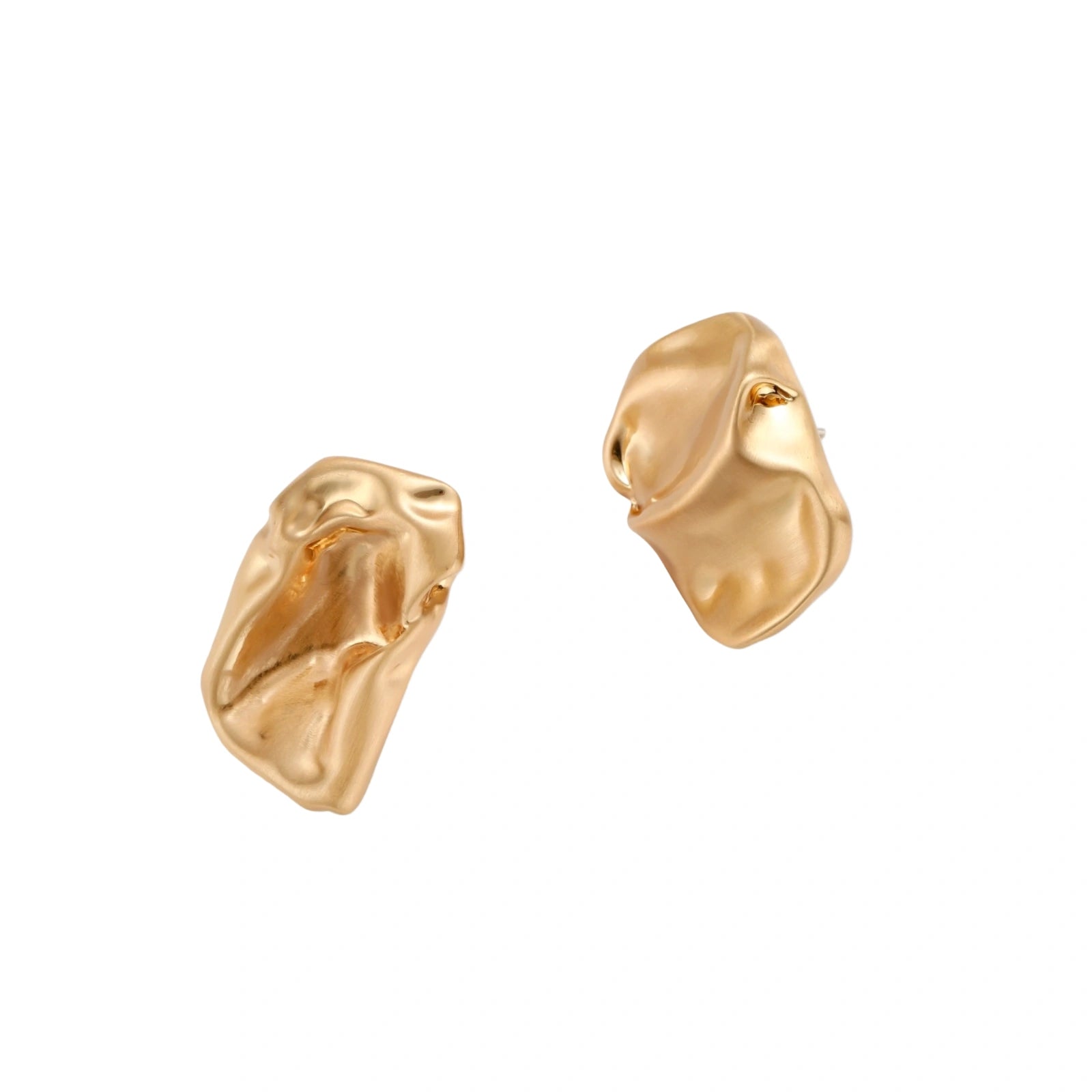 Sculptural gold-toned jewelry set with organic fluid shapes including earrings and layered chain necklace on cream background.