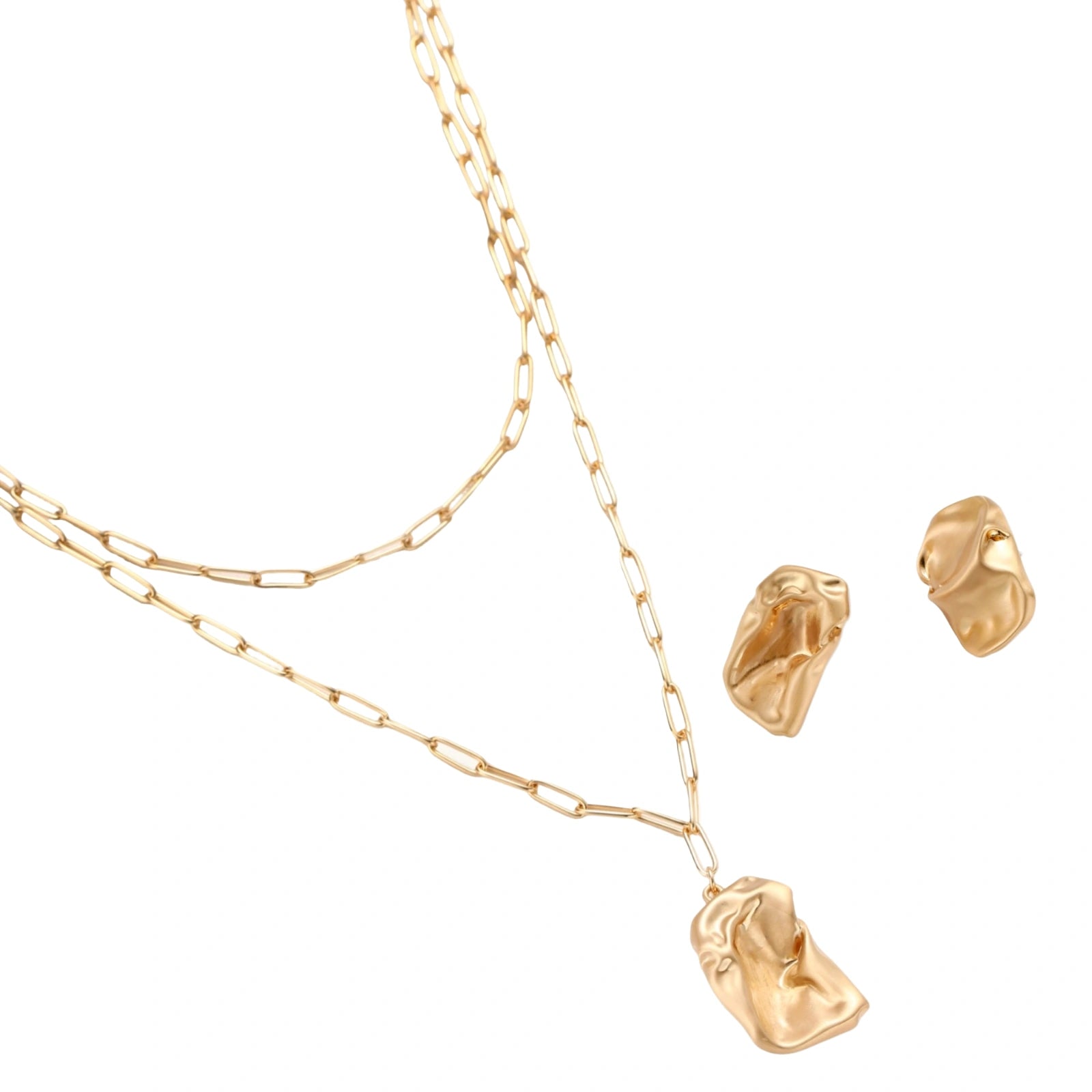 Sculptural gold-toned jewelry set with organic fluid shapes including earrings and layered chain necklace on cream background.