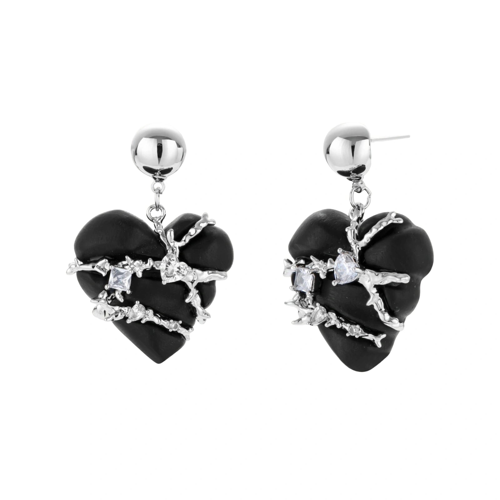 Dark ebony wood heart charms wrapped in intricate silver chains with crystal accents, shown as matching earrings and necklace set.
