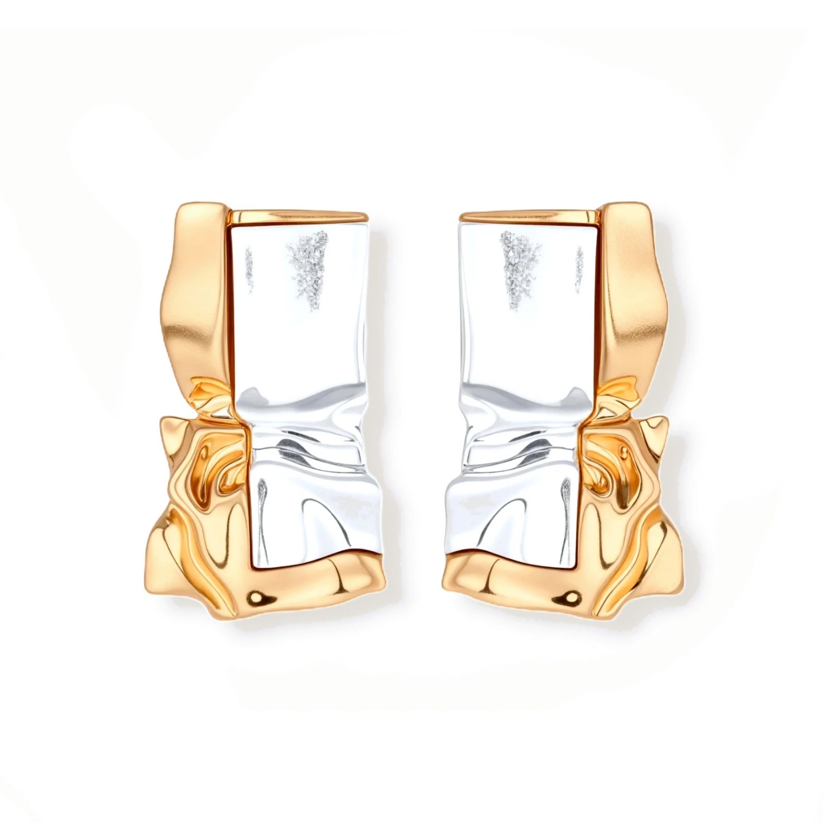 Close-up of avant-garde sculptural earrings with flowing liquid metal design in gold and silver tones on white background.
