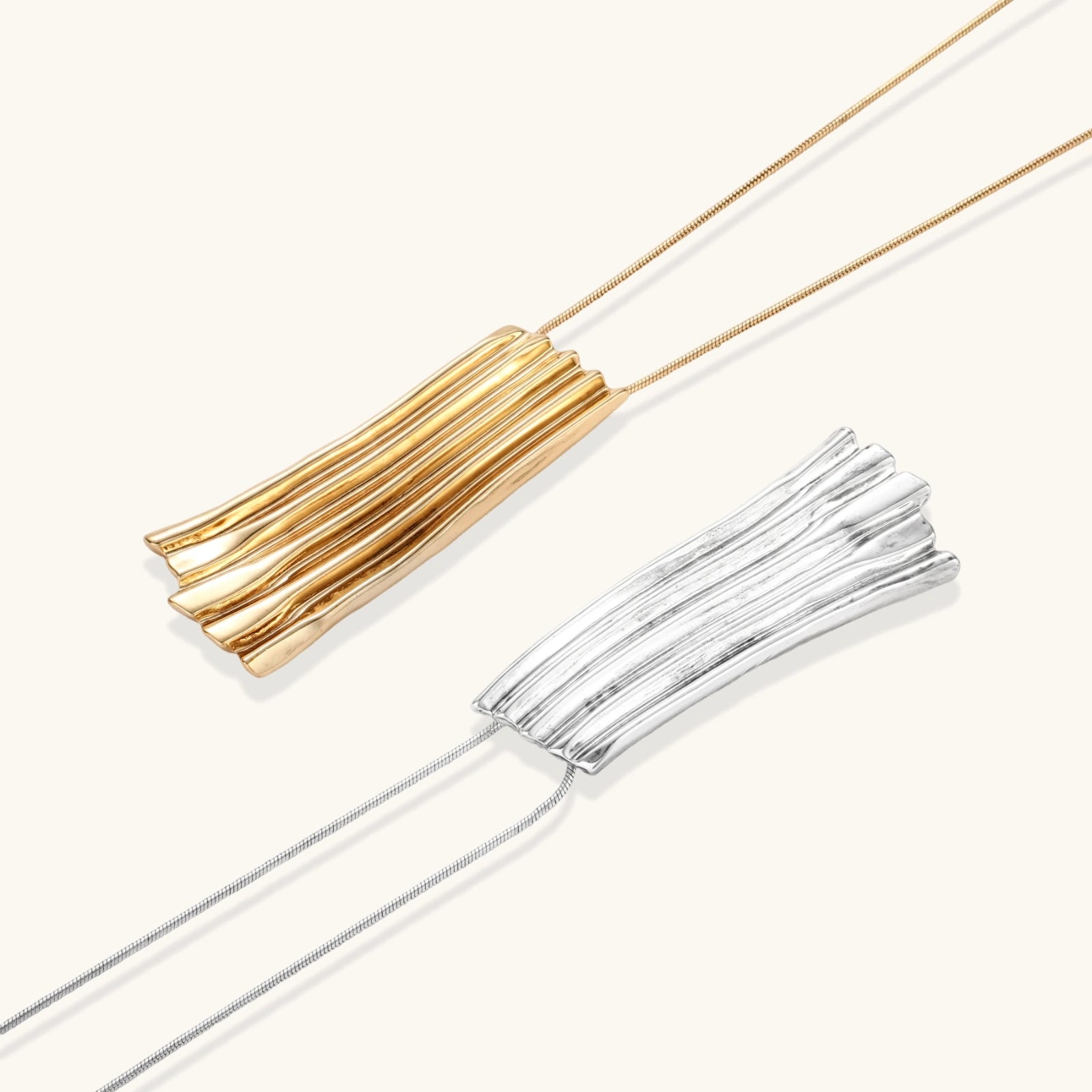 Modern adjustable necklace featuring geometric ribbed pendant with vertical lines in gold and silver finish options.