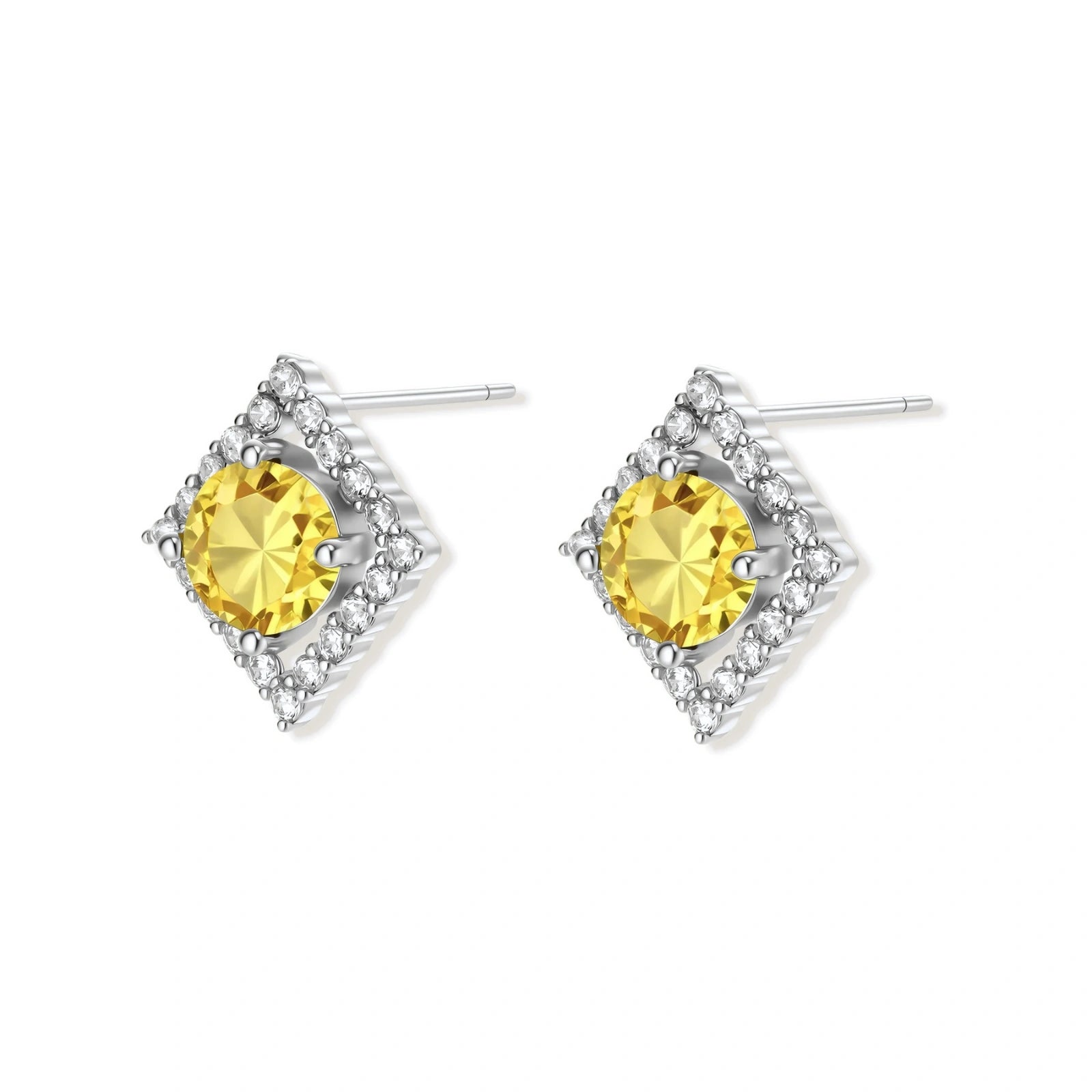Close-up of diamond-shaped stud earrings with yellow moissanite centers and clear stone halos in sterling silver setting