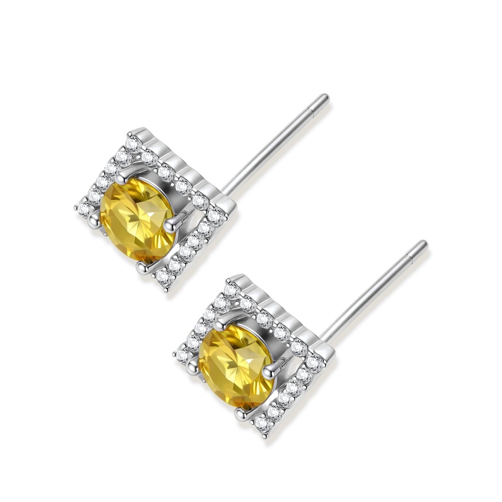 Close-up of diamond-shaped stud earrings with yellow moissanite centers and clear stone halos in sterling silver setting