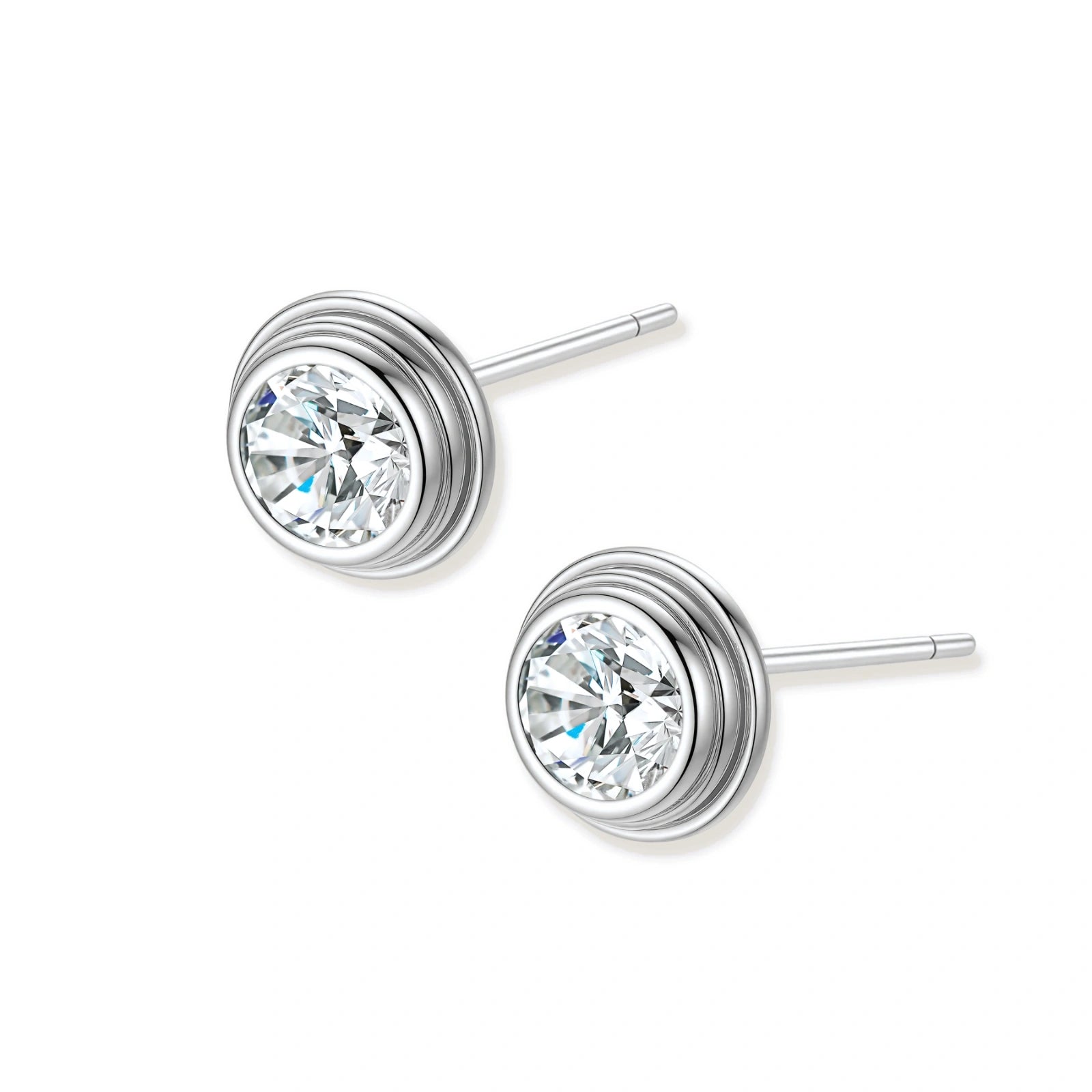 Close-up of sterling silver stud earrings featuring concentric circular frames with brilliant moissanite centers