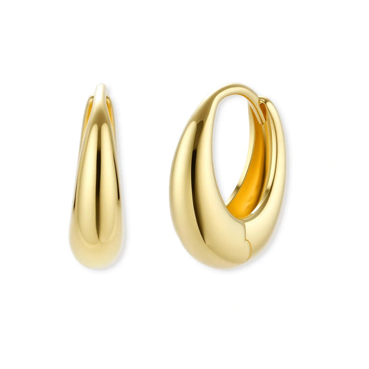 Chunky gold-plated sterling silver huggie hoop earrings with hinged closure mechanism on cream background.