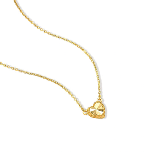 Dainty 14K gold-plated 925 sterling silver necklace with a small beaded-edge heart pendant and sunburst facets on a cream background.