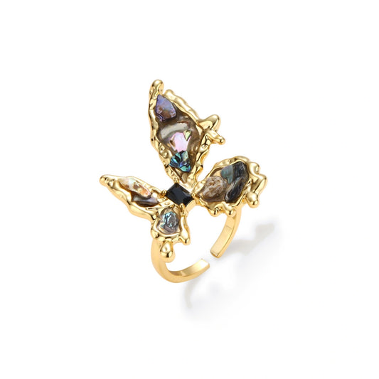 Gold-plated adjustable ring featuring iridescent shell pieces in purple, blue and green tones arranged in butterfly formation