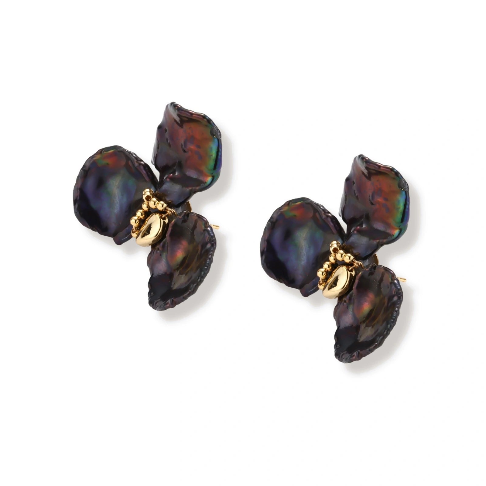 Dark iridescent baroque pearls arranged in flower pattern with 18K gold-plated center on cream background.