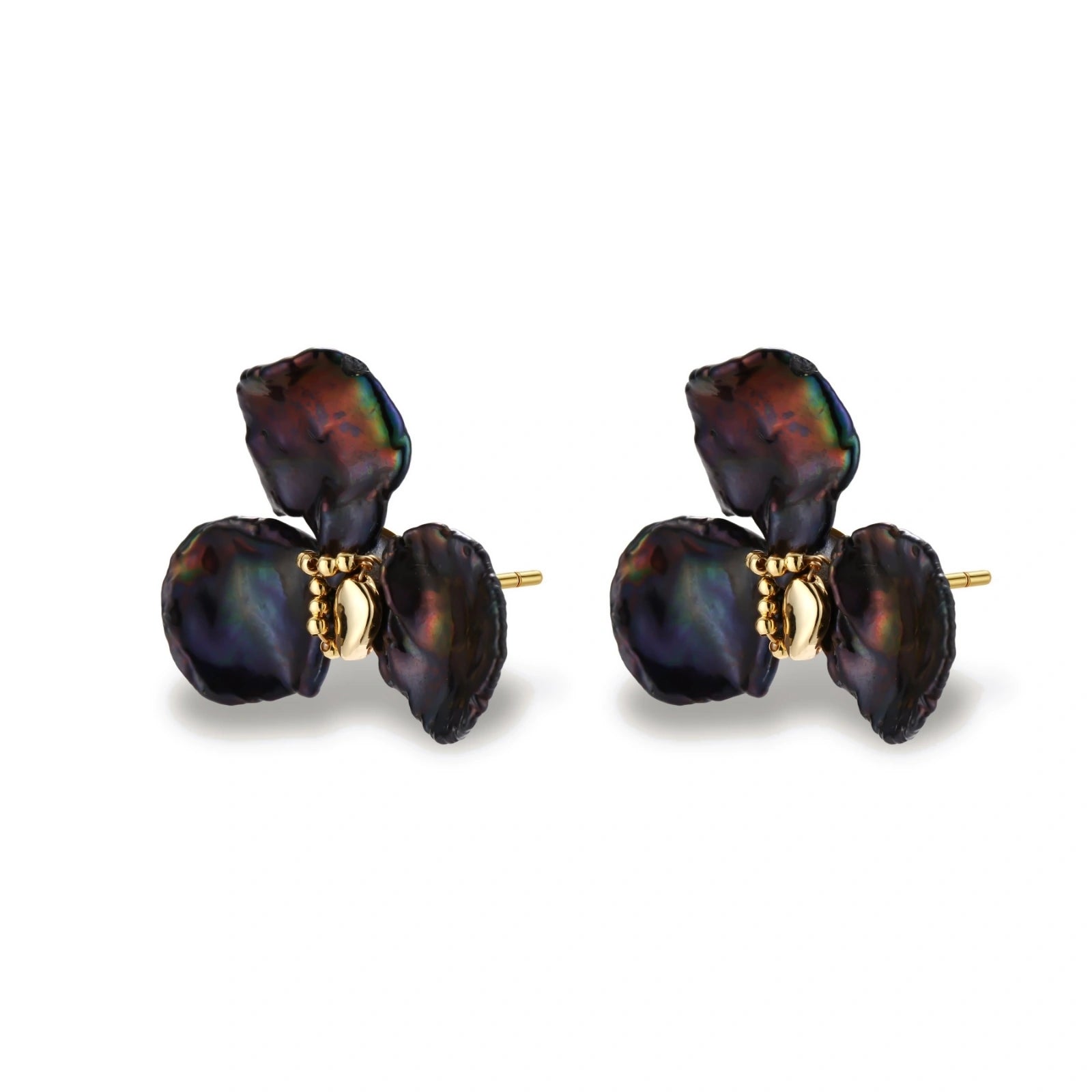 Dark iridescent baroque pearls arranged in flower pattern with 18K gold-plated center on cream background.