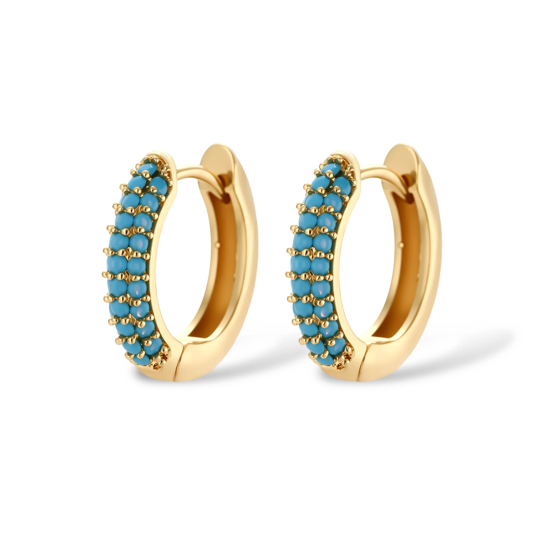 Gold-plated curved necklace and hoop earrings with turquoise cubic zirconia stones on white background.