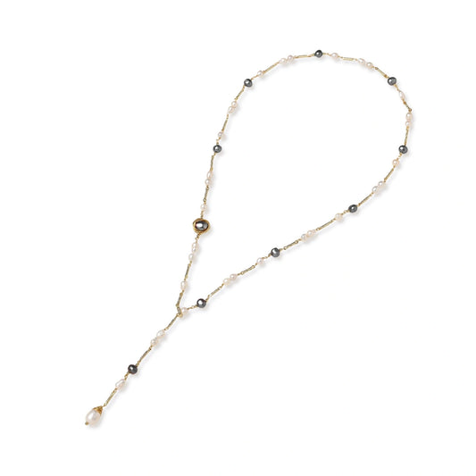 Y-shaped gold-plated necklace with white and gray freshwater pearls on cream background, showing adjustable drop design.